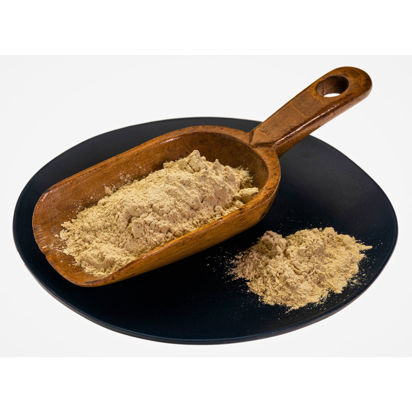 Ashwagandha root powder in wooden scoop on black plate, natural adaptogen herb supplement