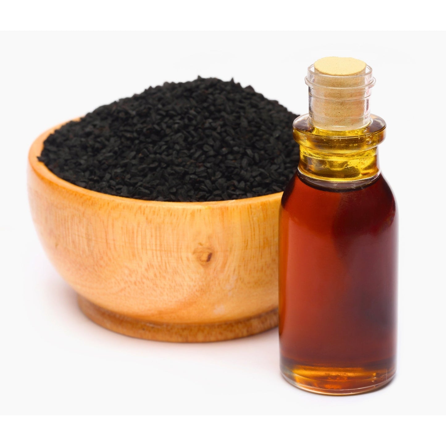 Bottle of pure Ethiopian Black Seed Oil next to a wooden bowl filled with black seeds