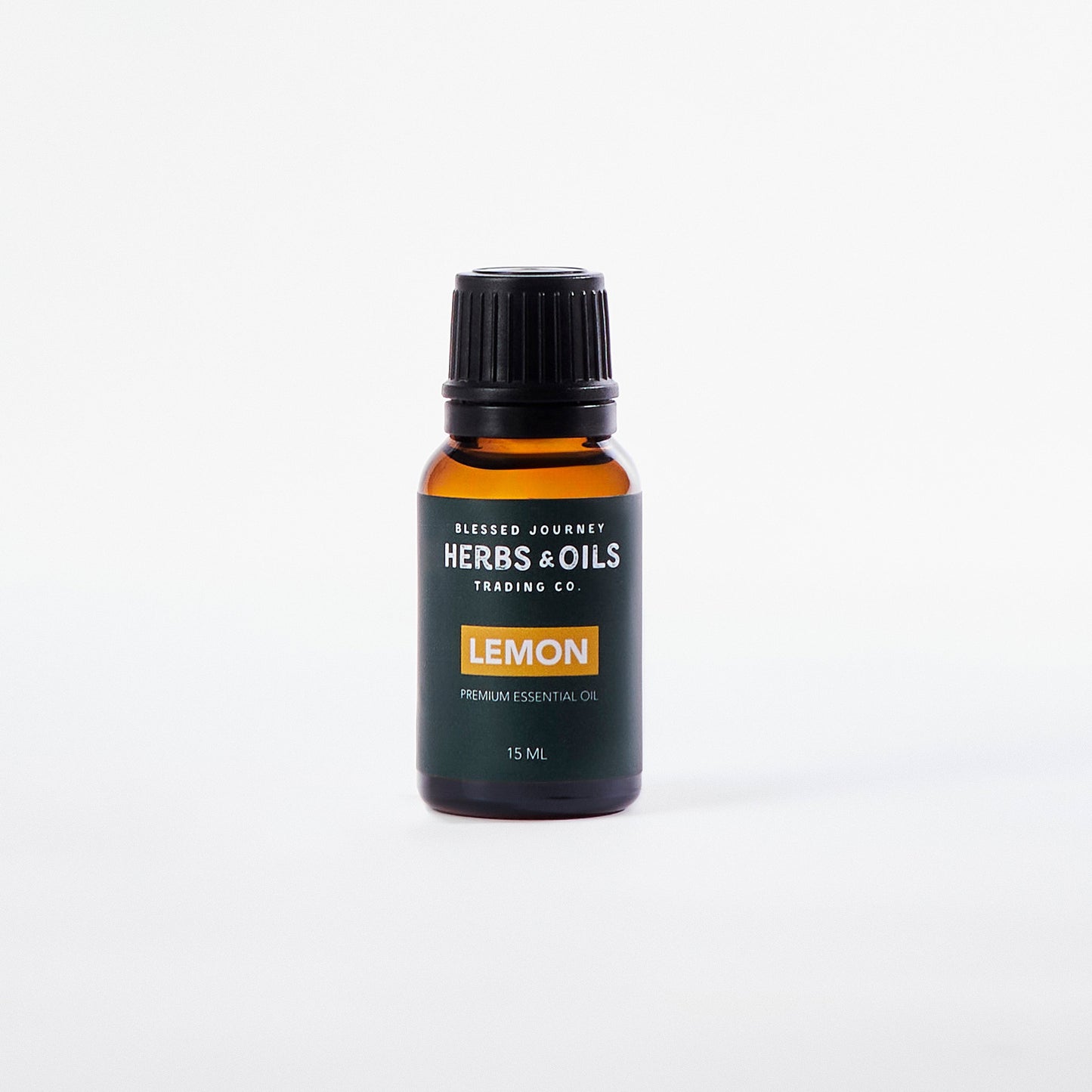 15ml amber glass bottle of lemon essential oil with black cap on white background