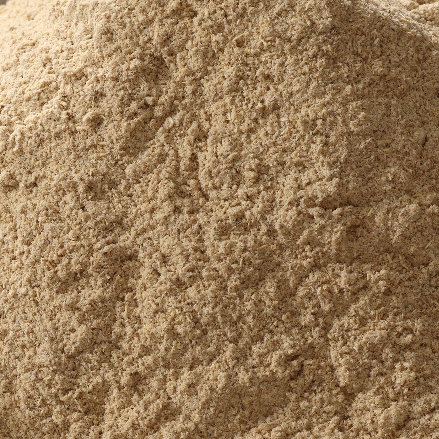Close-up of finely powdered Ashwagandha root powder, light brown dried herb powder for stress and vitality support